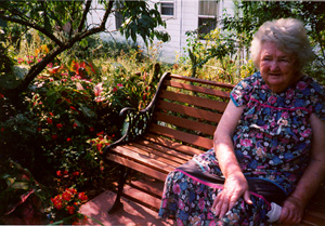 Mother on bench in garden